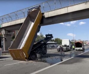 Lifted Trailer Hits Pedestrian Bridge On Motorway As Person Walks On